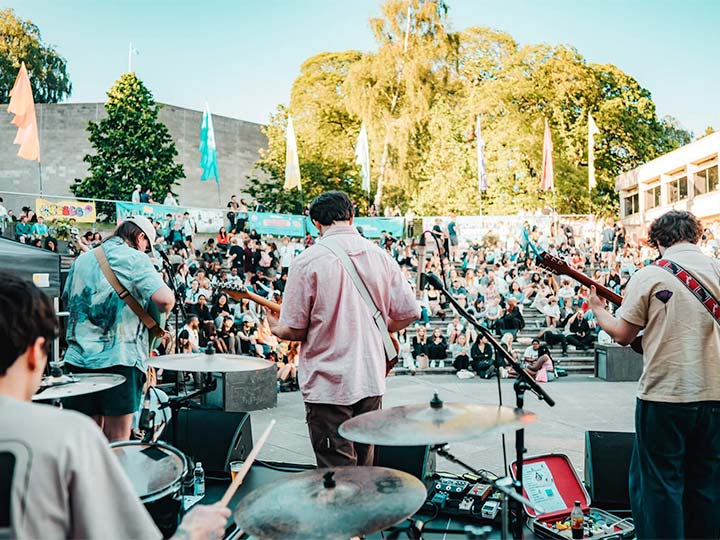 A photograph of a band playing on The Square on a sunny day