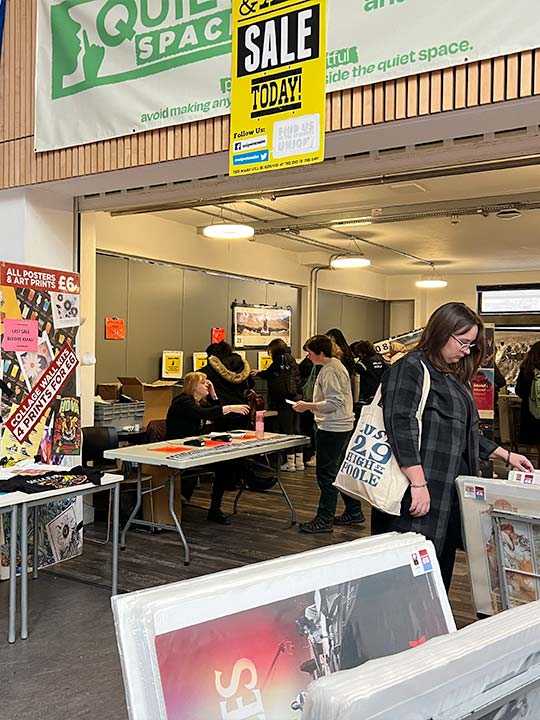A photograph of a poster sale in the exhibition space