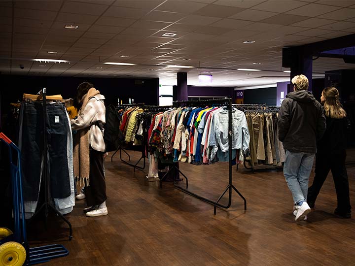 A photograph of a vintage clothes sale in the exhibition space