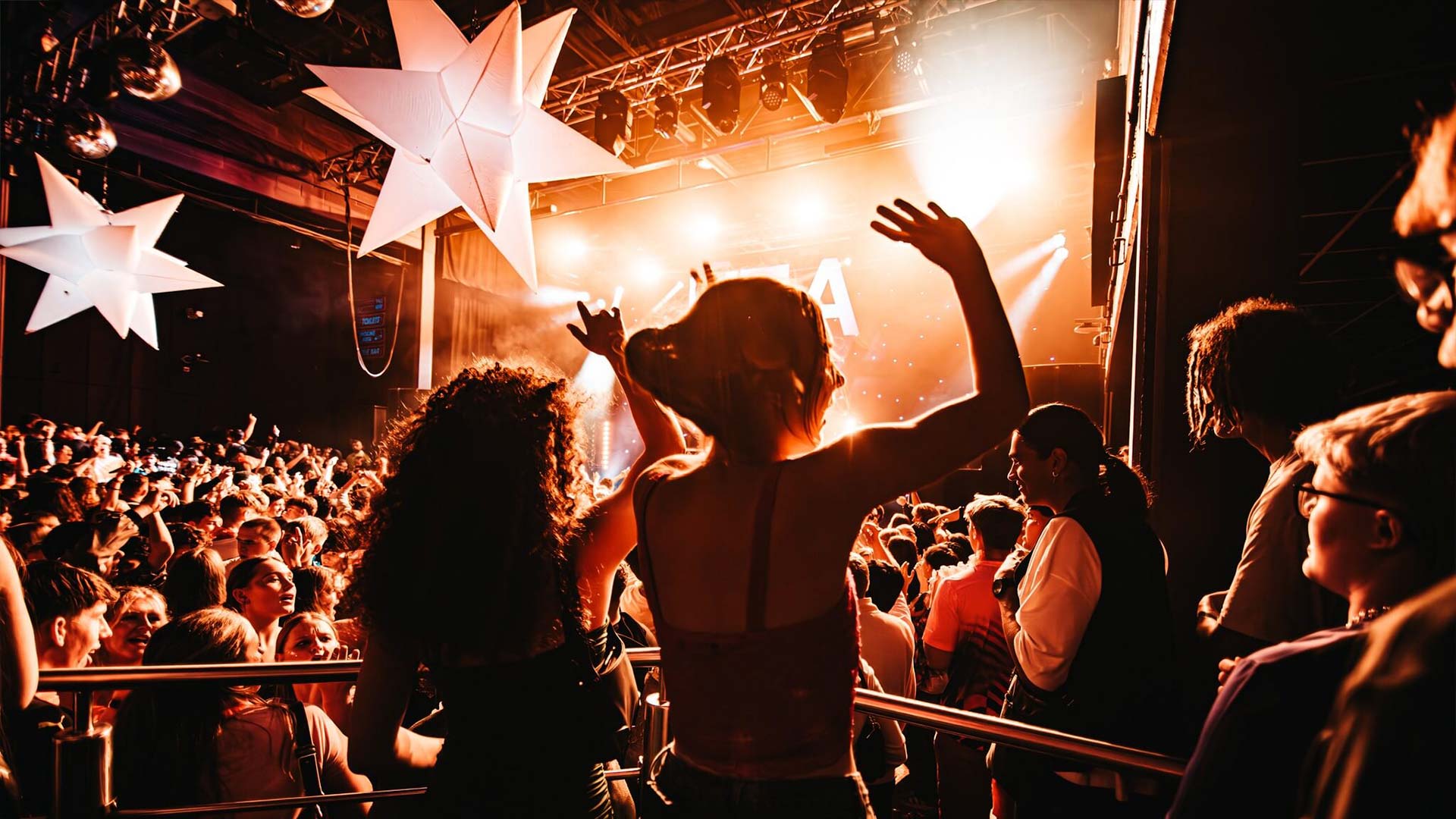 A photograph of students dancing at a club event