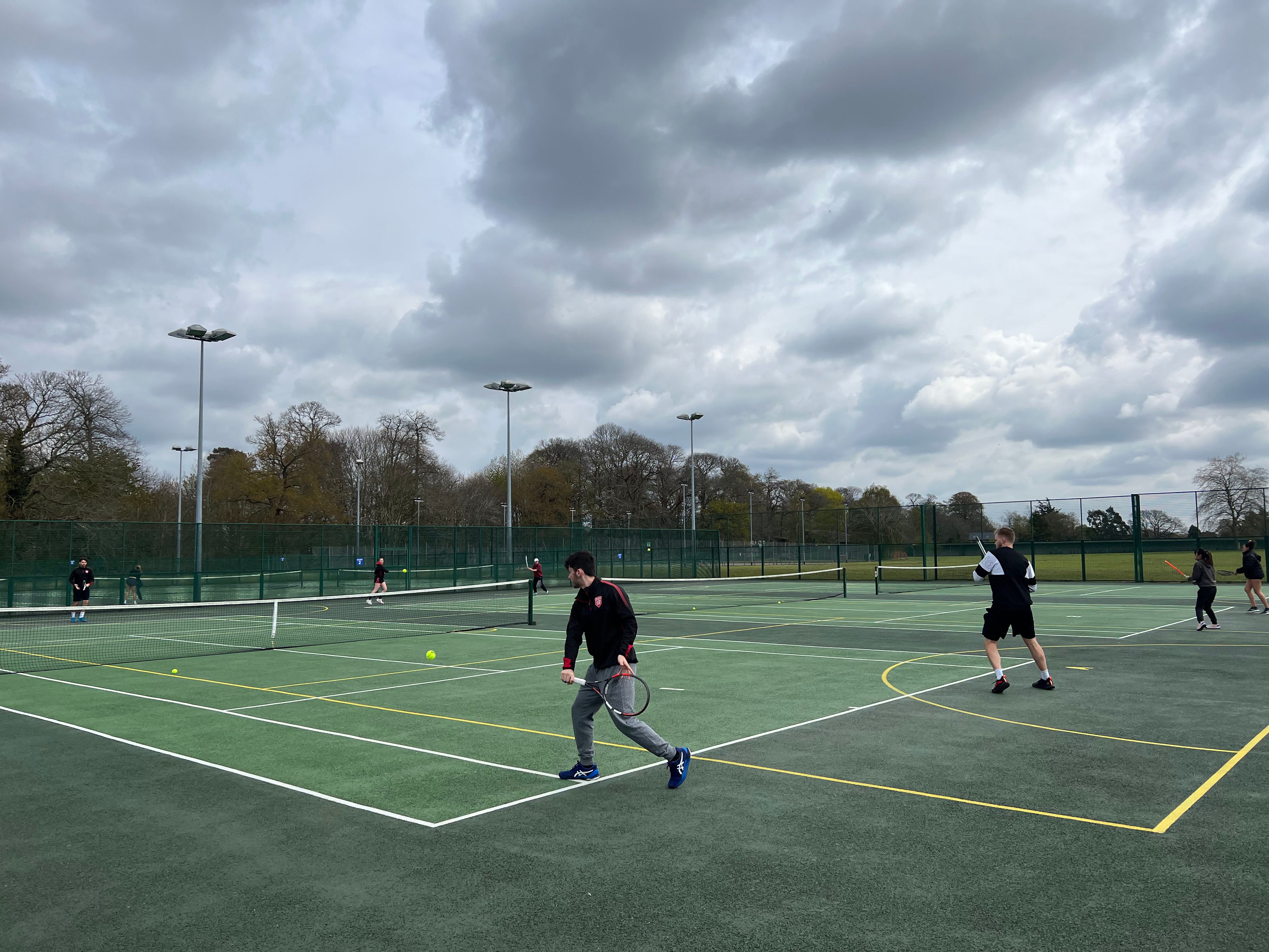 A photograph of a students playing tennis