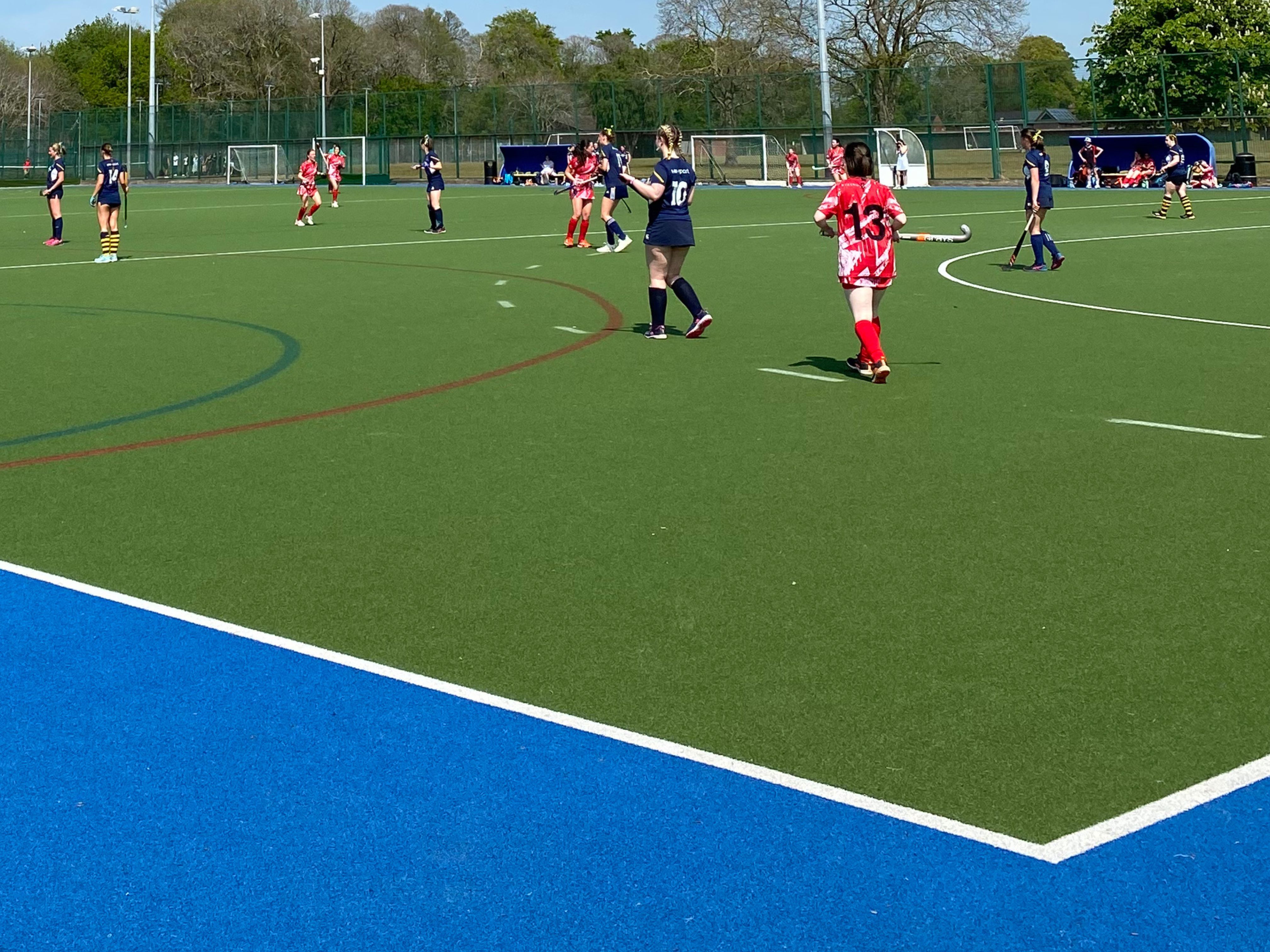A photograph of a students playing football on a pitch