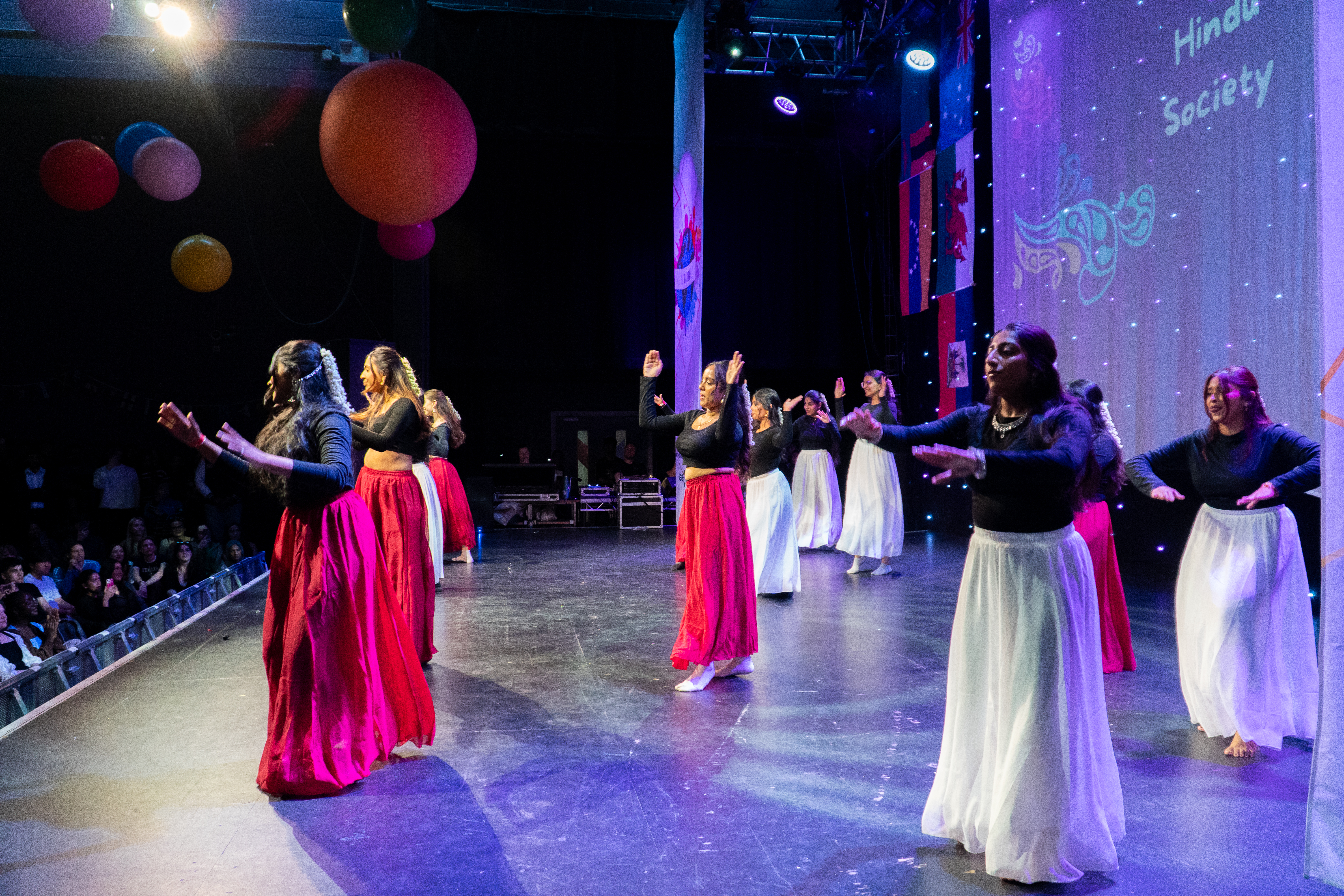 A photograph of students dancing on stage