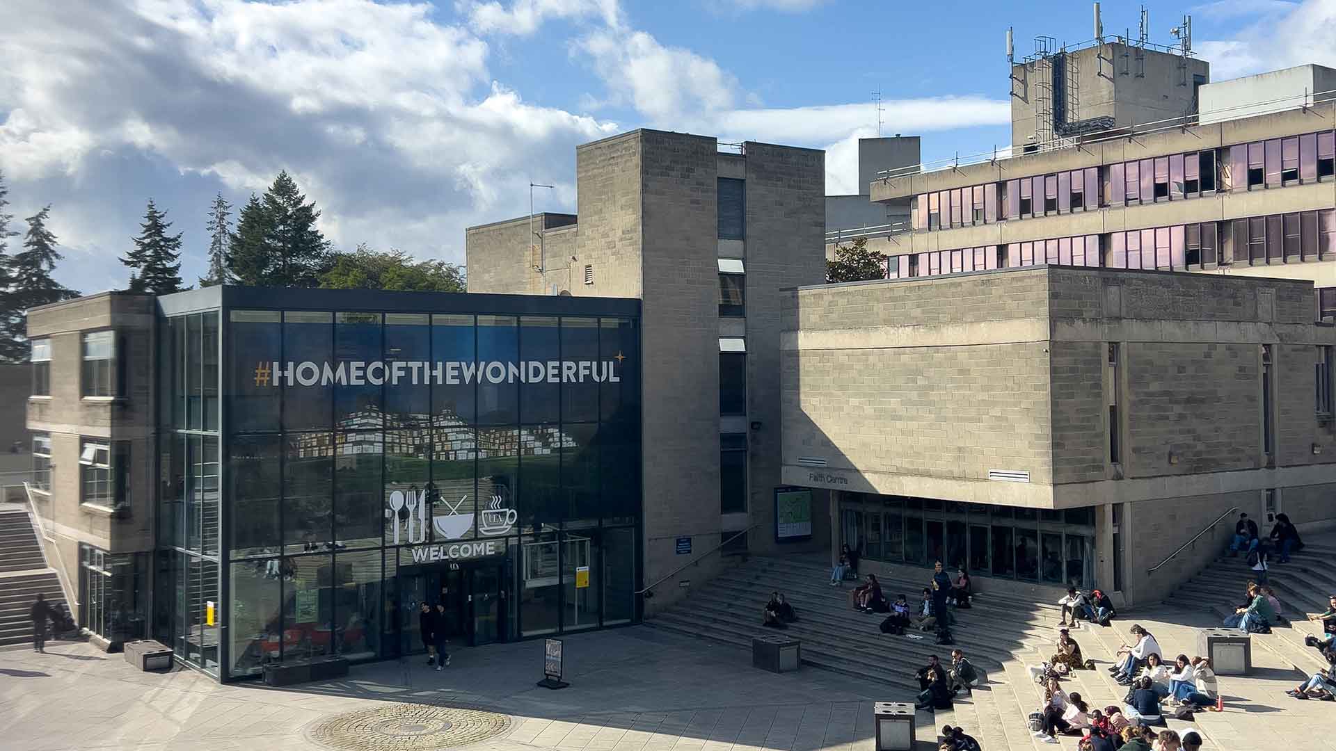 A photograph of a UEA building that says #HomeOfTheWonderful across the windows