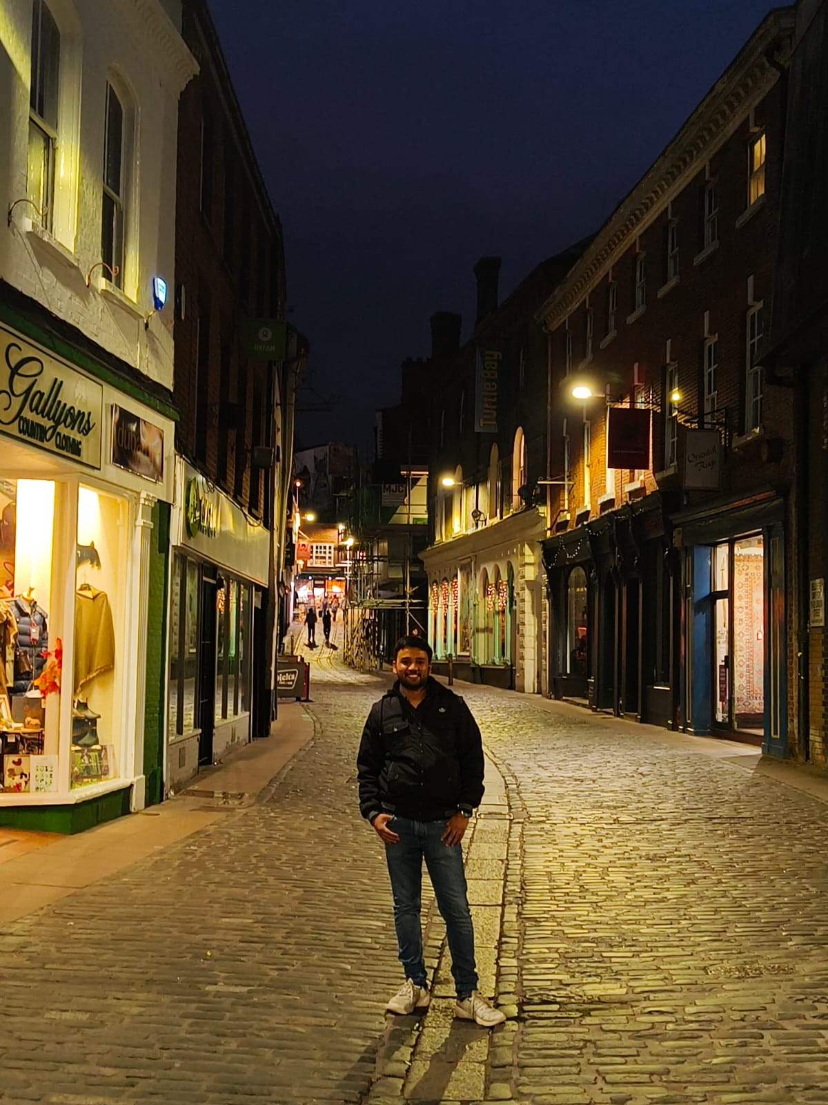 photo of Aditya in the middle of a walkway smiling